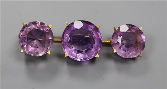 A yellow metal and three stone amethyst set brooch, 44mm.